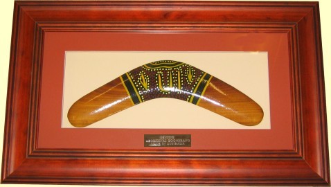 Framed Aboriginal dot art boomerang, 18 inch. Engraved logo and text