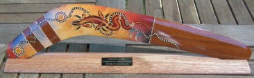 Contemporary art hunting boomerang on stand with engraved logo